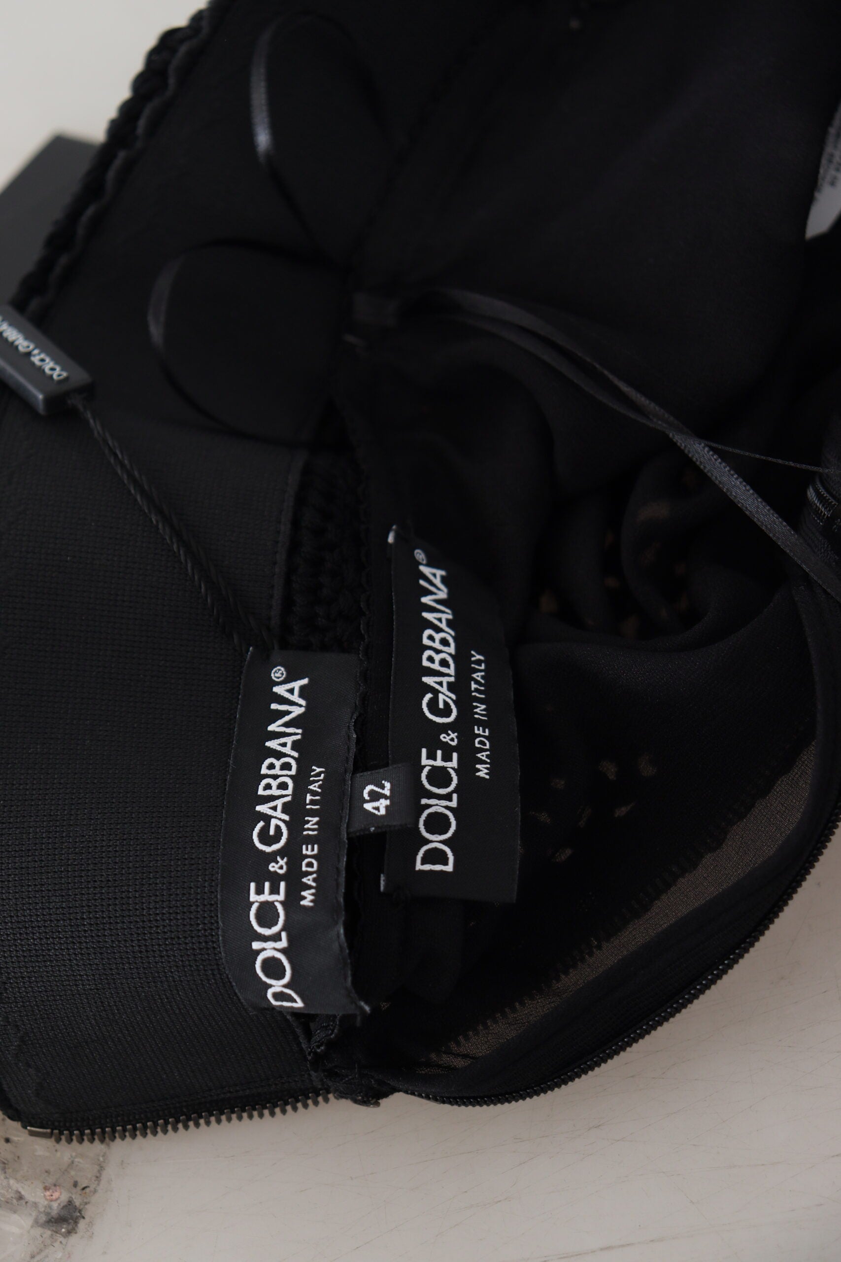 Black cap with white brand tags
