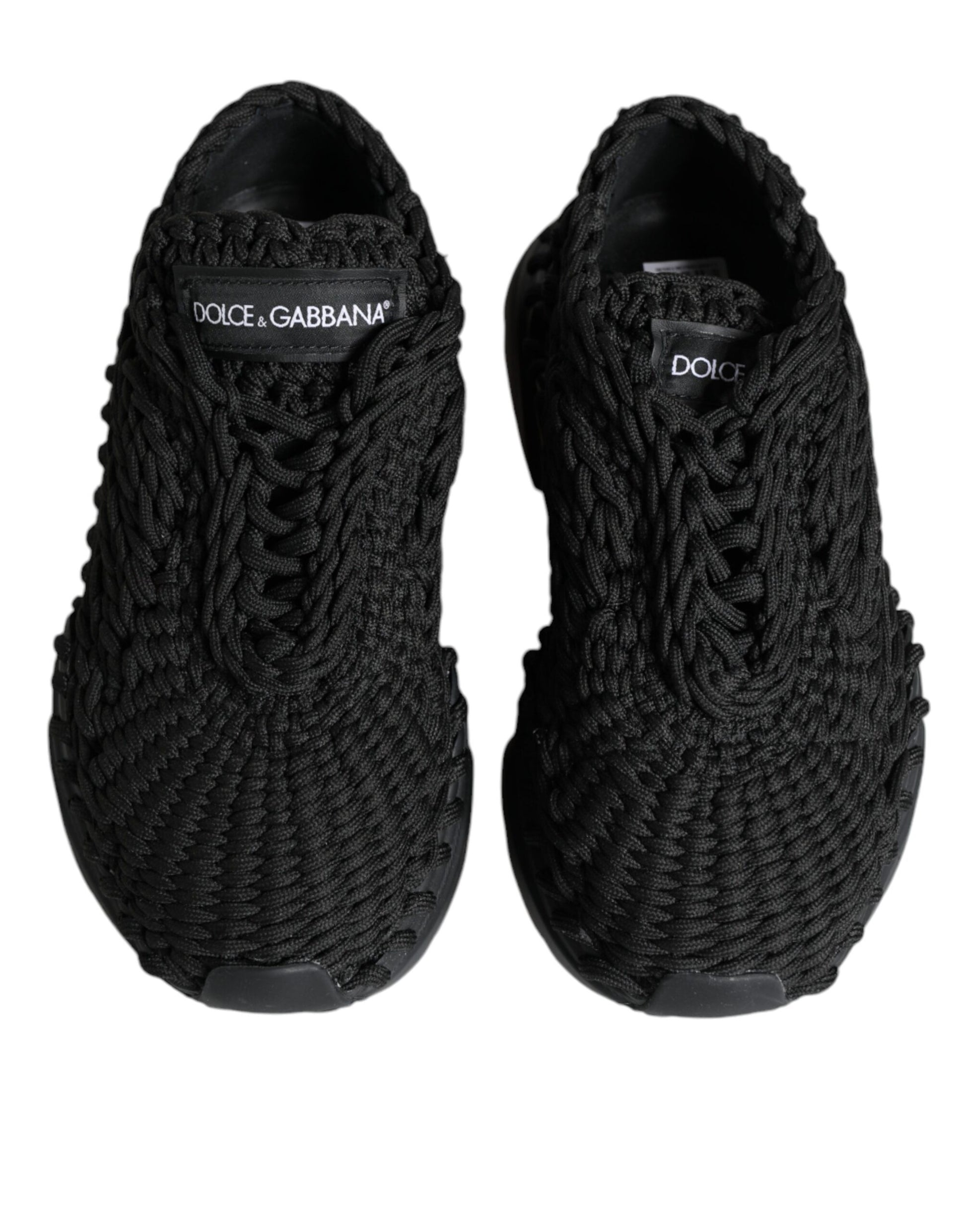 Pair of black sneakers with white branding and laces