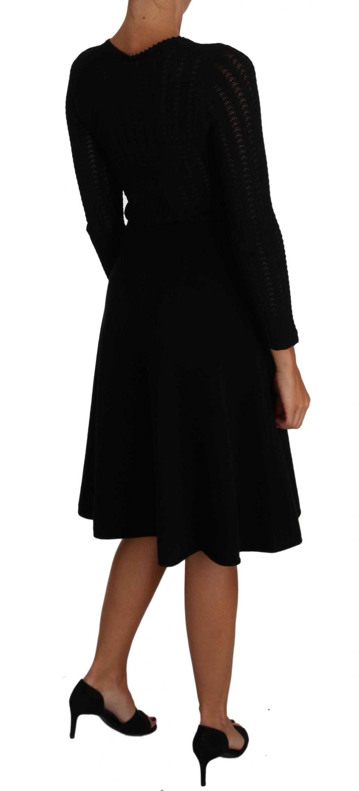 A black knit dress with long sleeves and a sheath silhouette