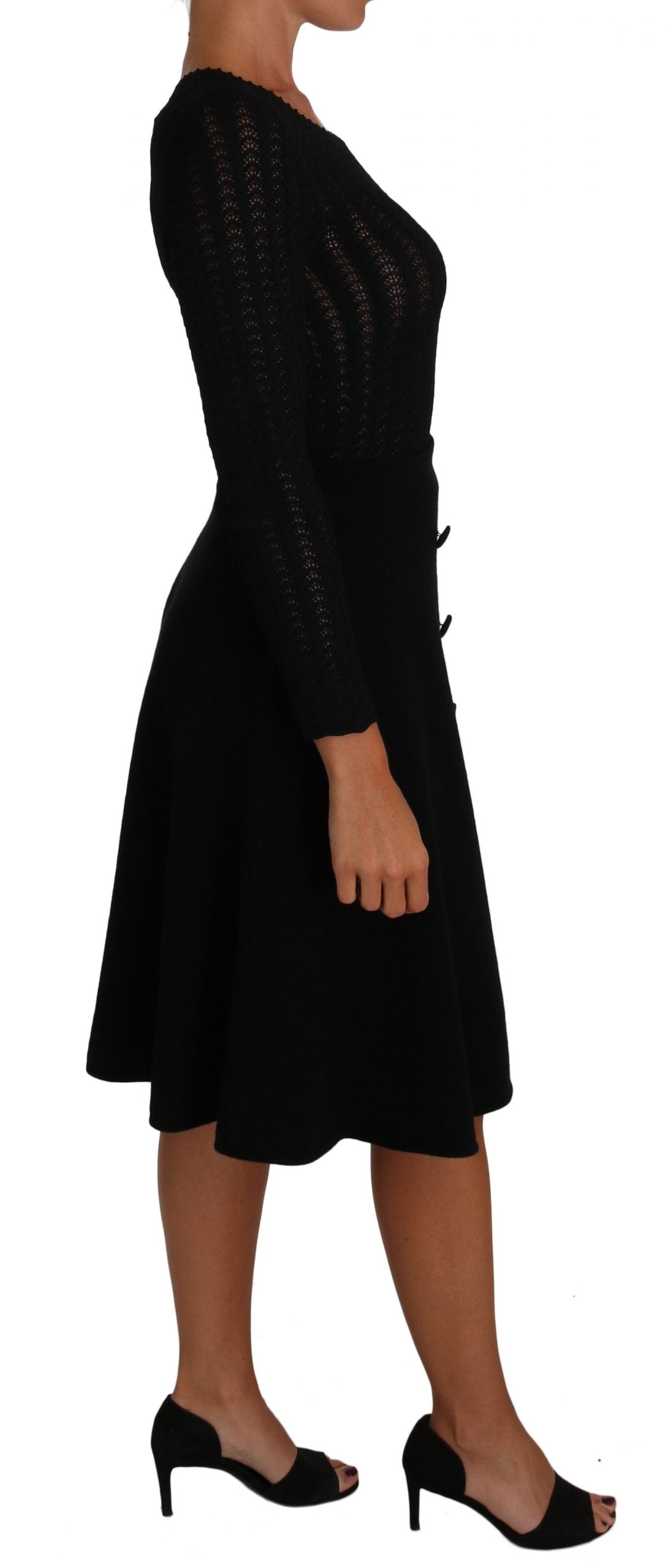 A black knit dress with long sleeves and a sheath silhouette