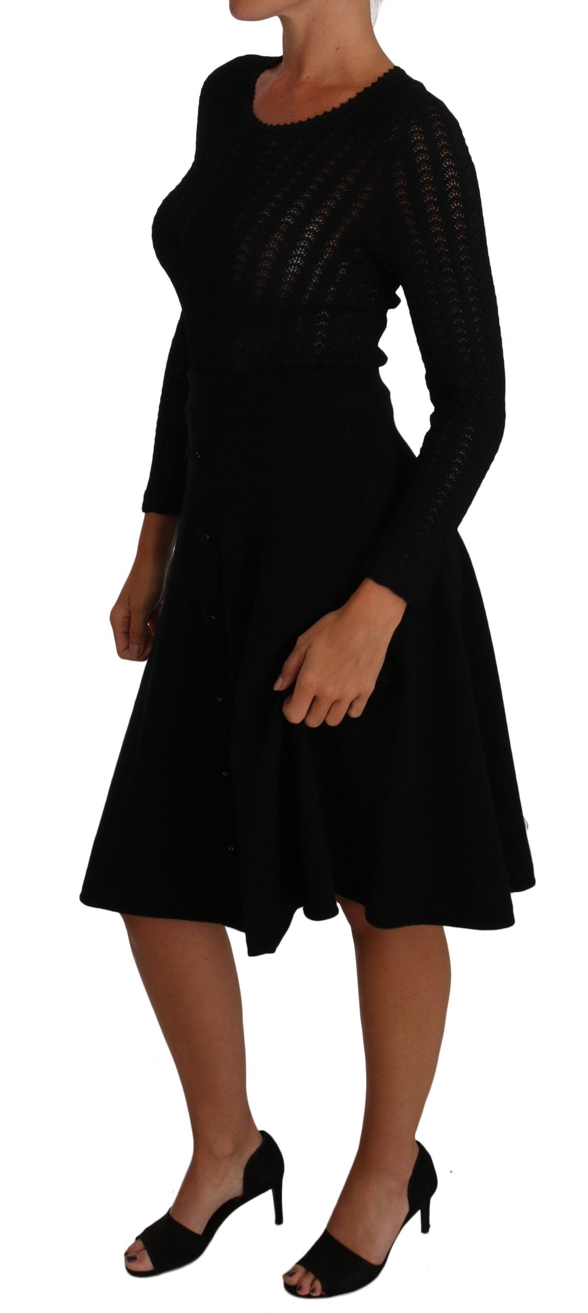 A black knit dress with long sleeves and a sheath silhouette