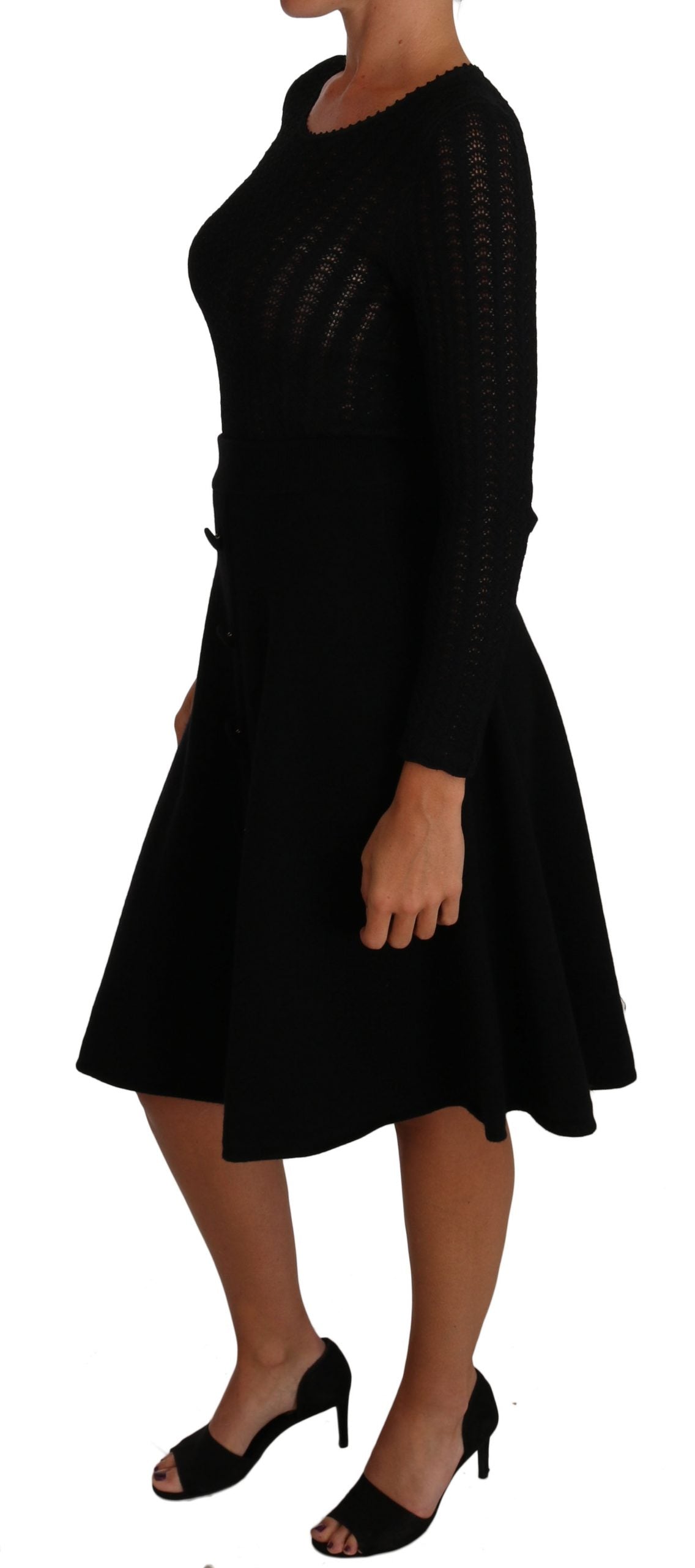 A black knit dress with long sleeves and a sheath style skirt