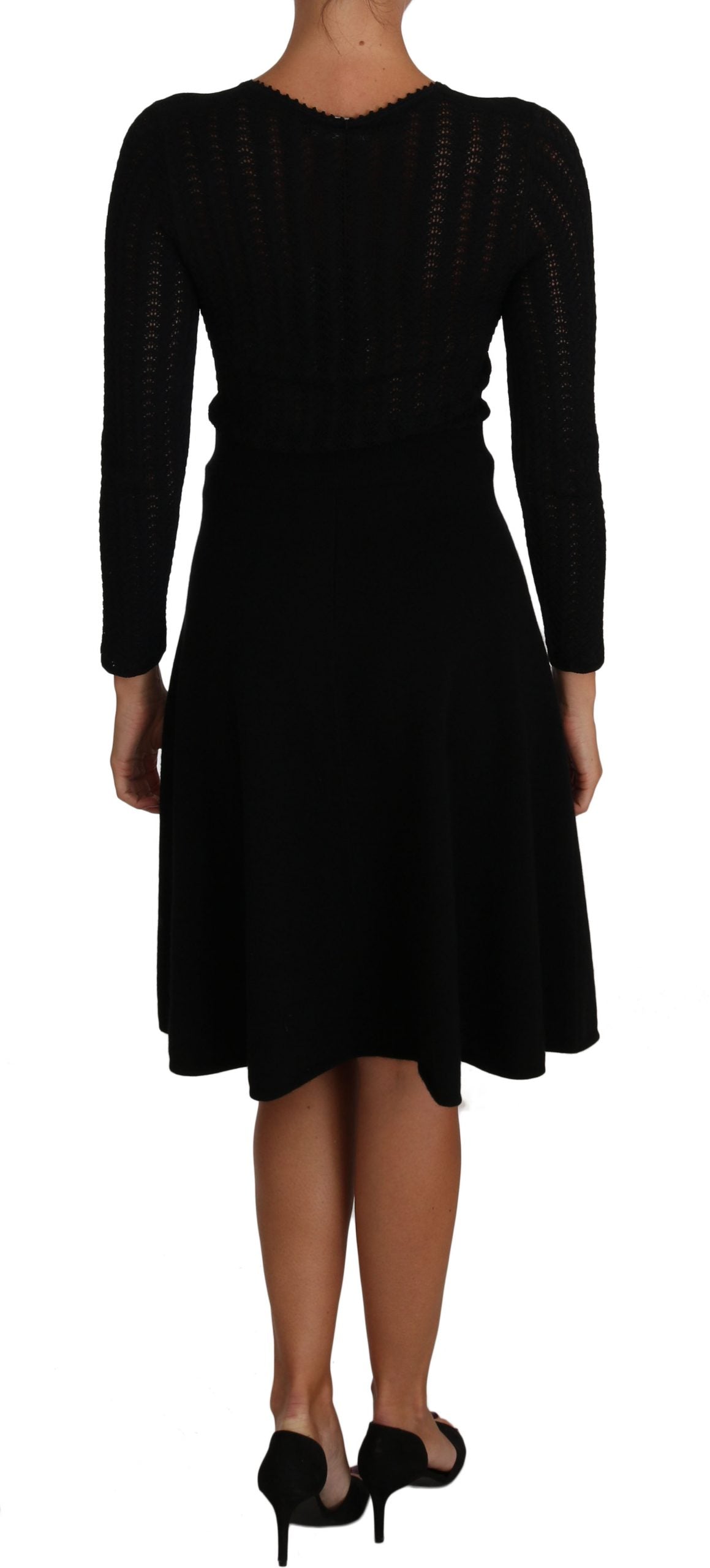 A black knit dress with long sleeves and a sheath silhouette