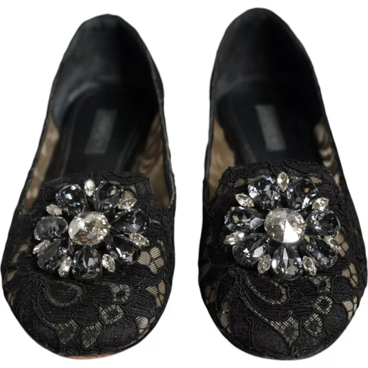 Pair of black shoes with a large sparkling jewel on top