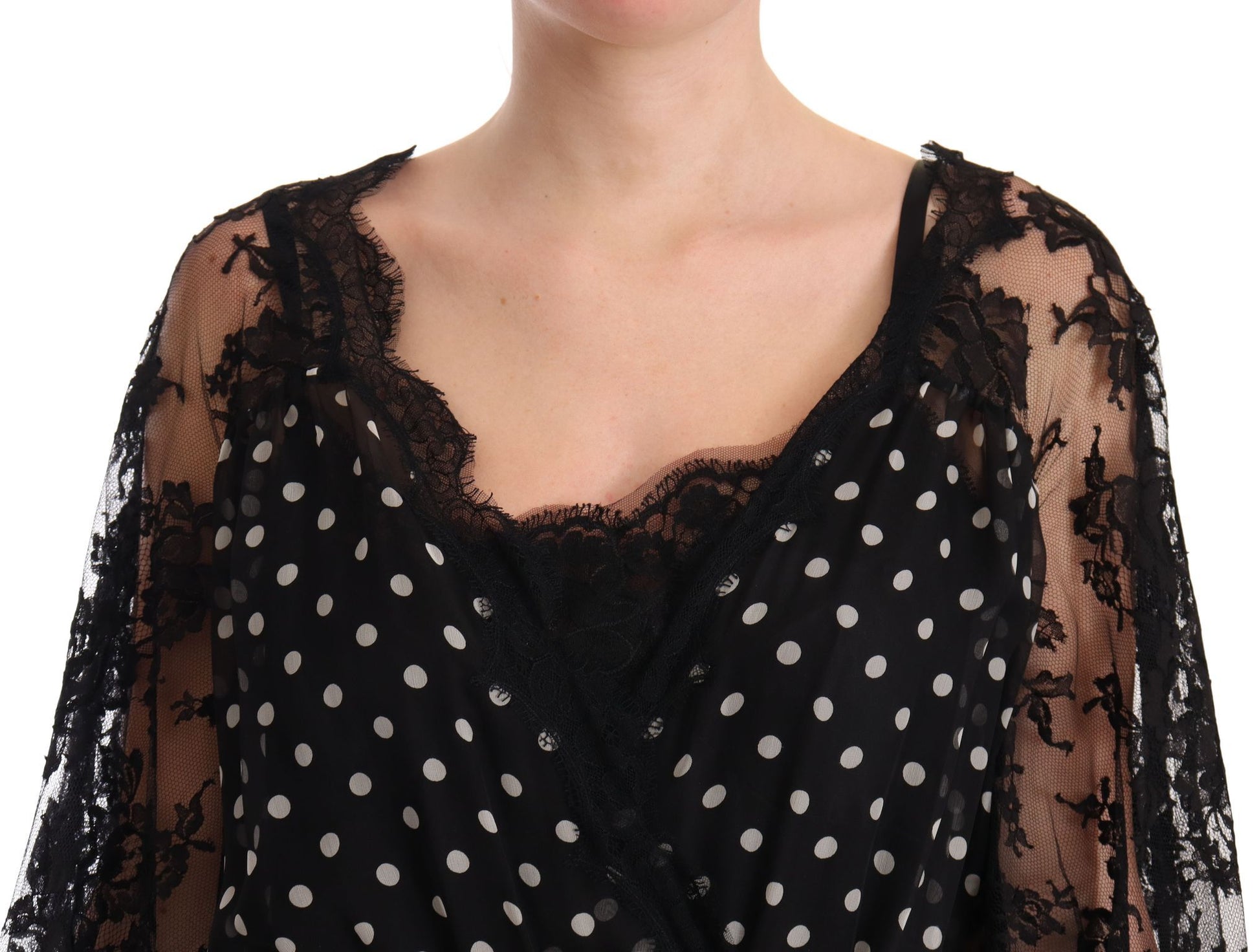 A black lace dress with floral polka dots and a sheer overlay