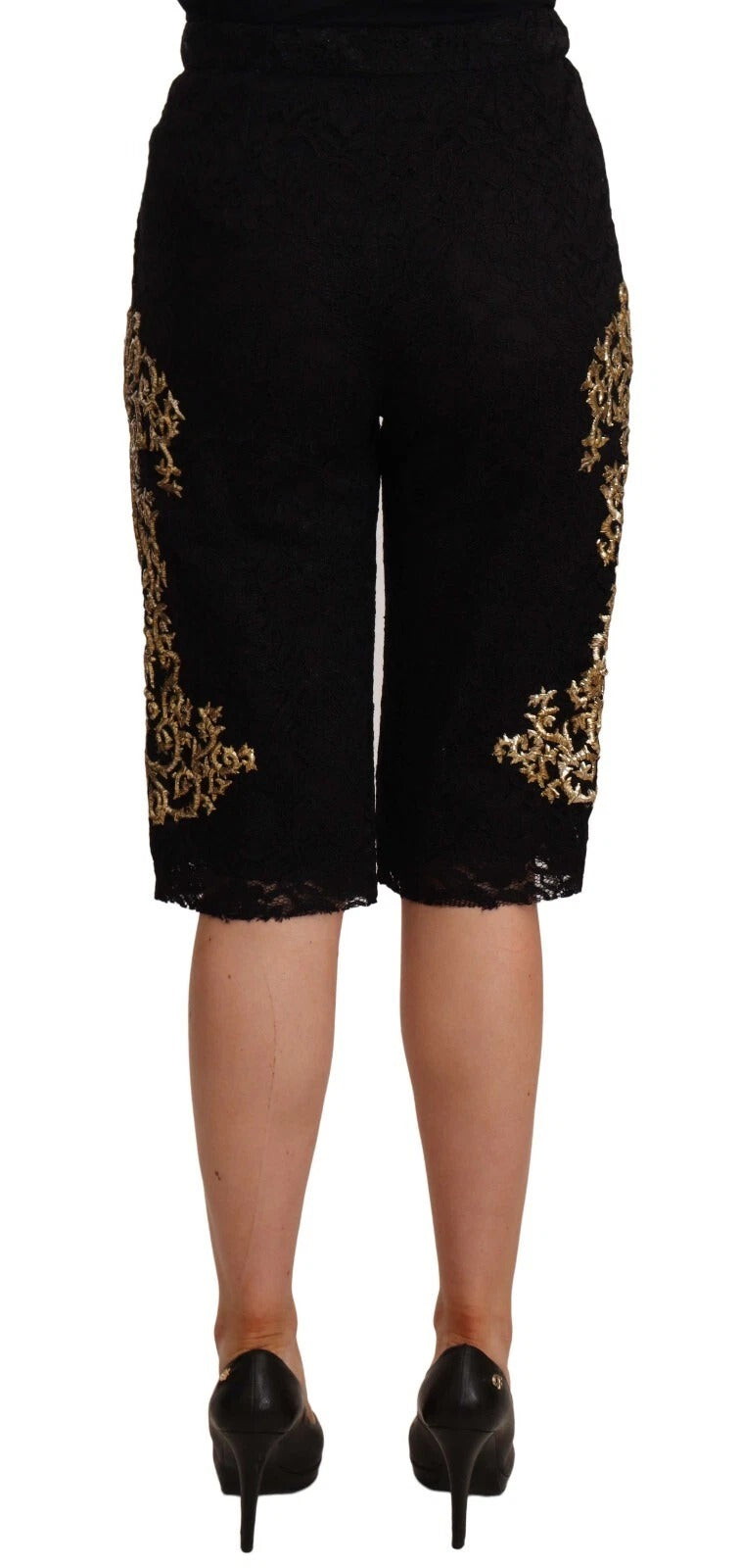A pair of black lace shorts with gold baroque detailing