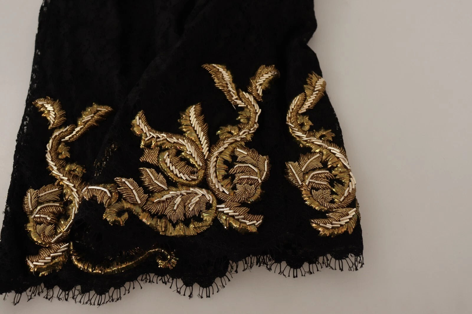 A pair of black lace shorts with gold baroque embroidery