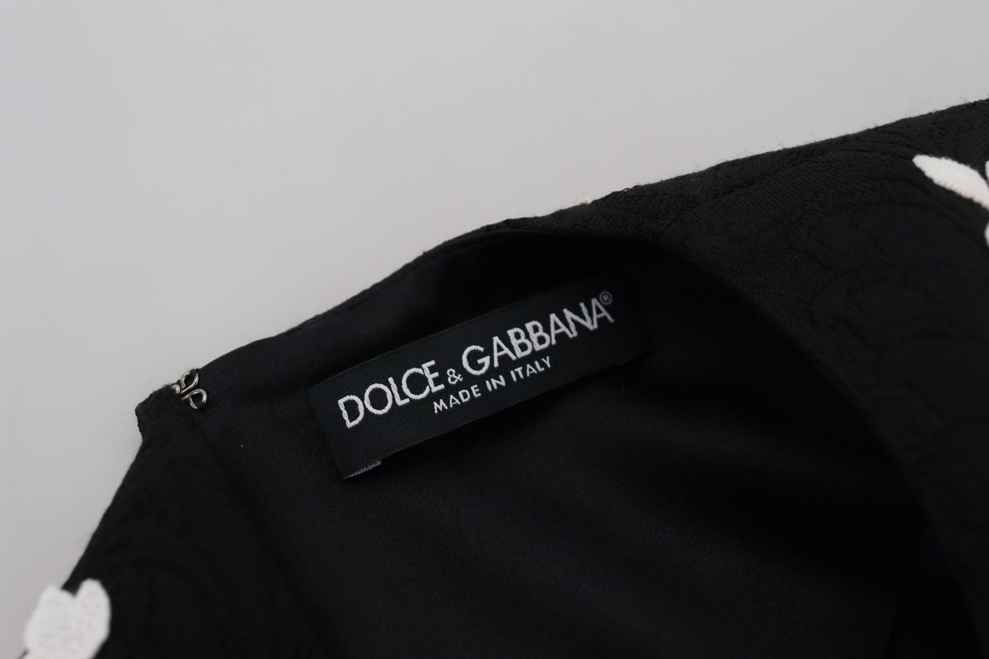 A black lace trim half sleeve dress from Dolce & Gabbana. It features an A-line silhouette and is adorned wit