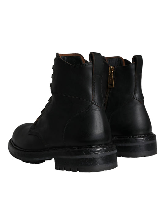 Pair of black leather boots with laces and a zipper on top