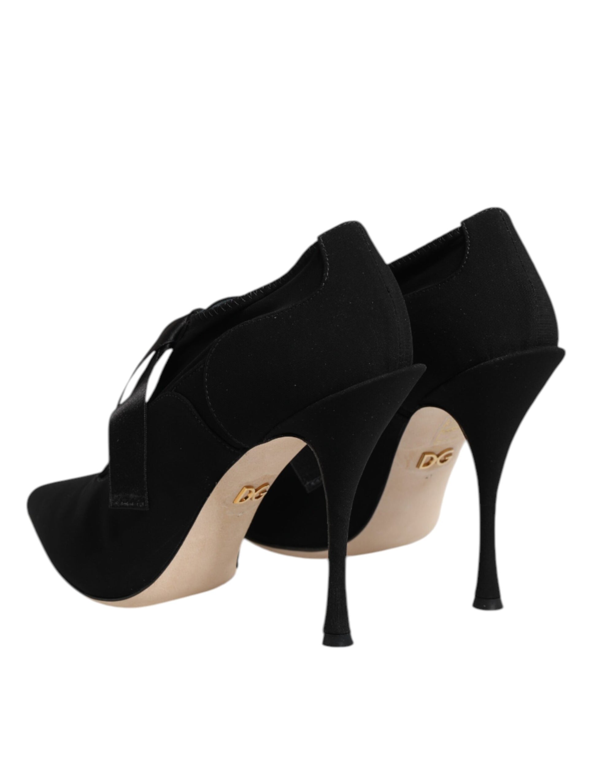 Pair of black high heel shoes with tan soles