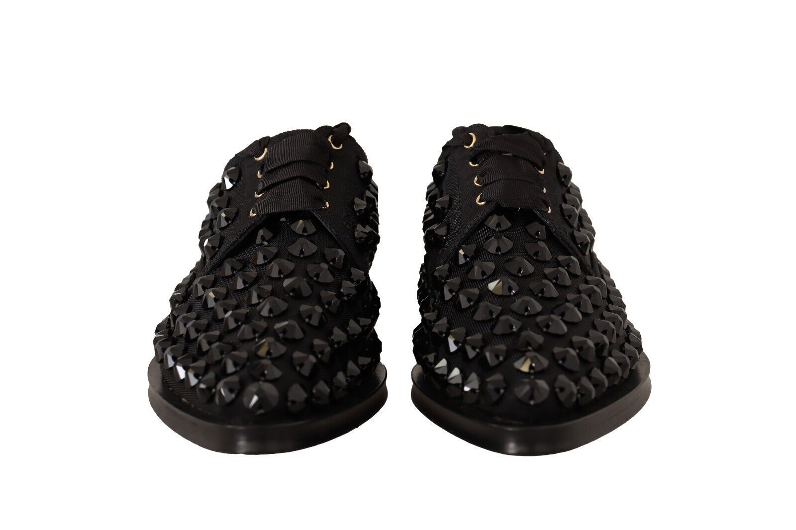 Pair of black glittery women's sandals with gold buckles and straps