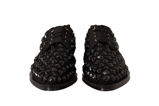 Pair of black glittery women's sandals with gold buckles and straps
