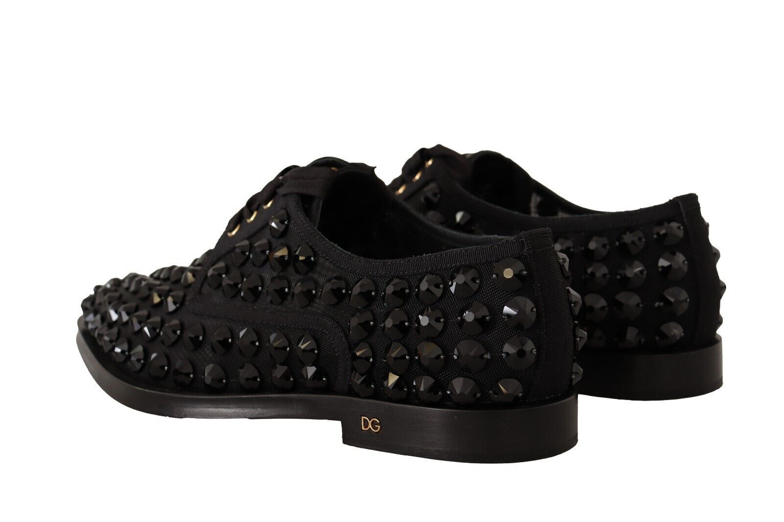 Pair of black shoes with studded detailing and a small logo on the side