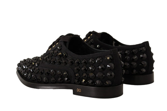 Pair of black shoes with studded detailing and a small logo on the side