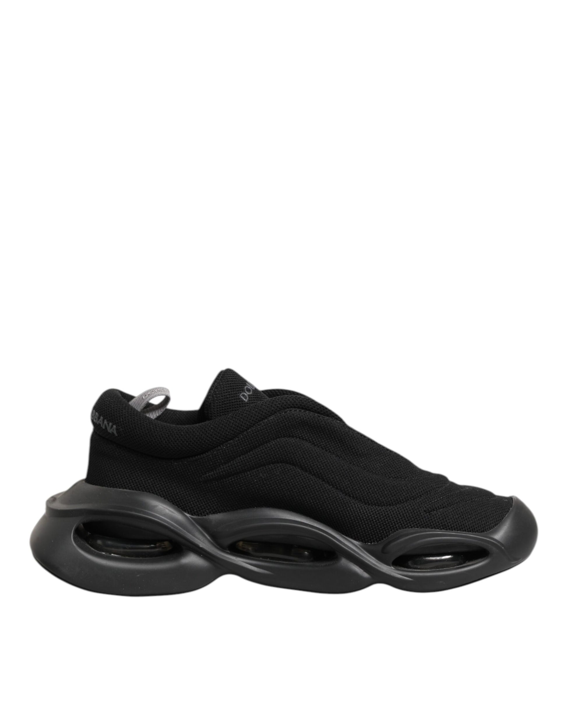 A black lace-up sneaker with a wave design on the sole, featuring a low top and a textured upper