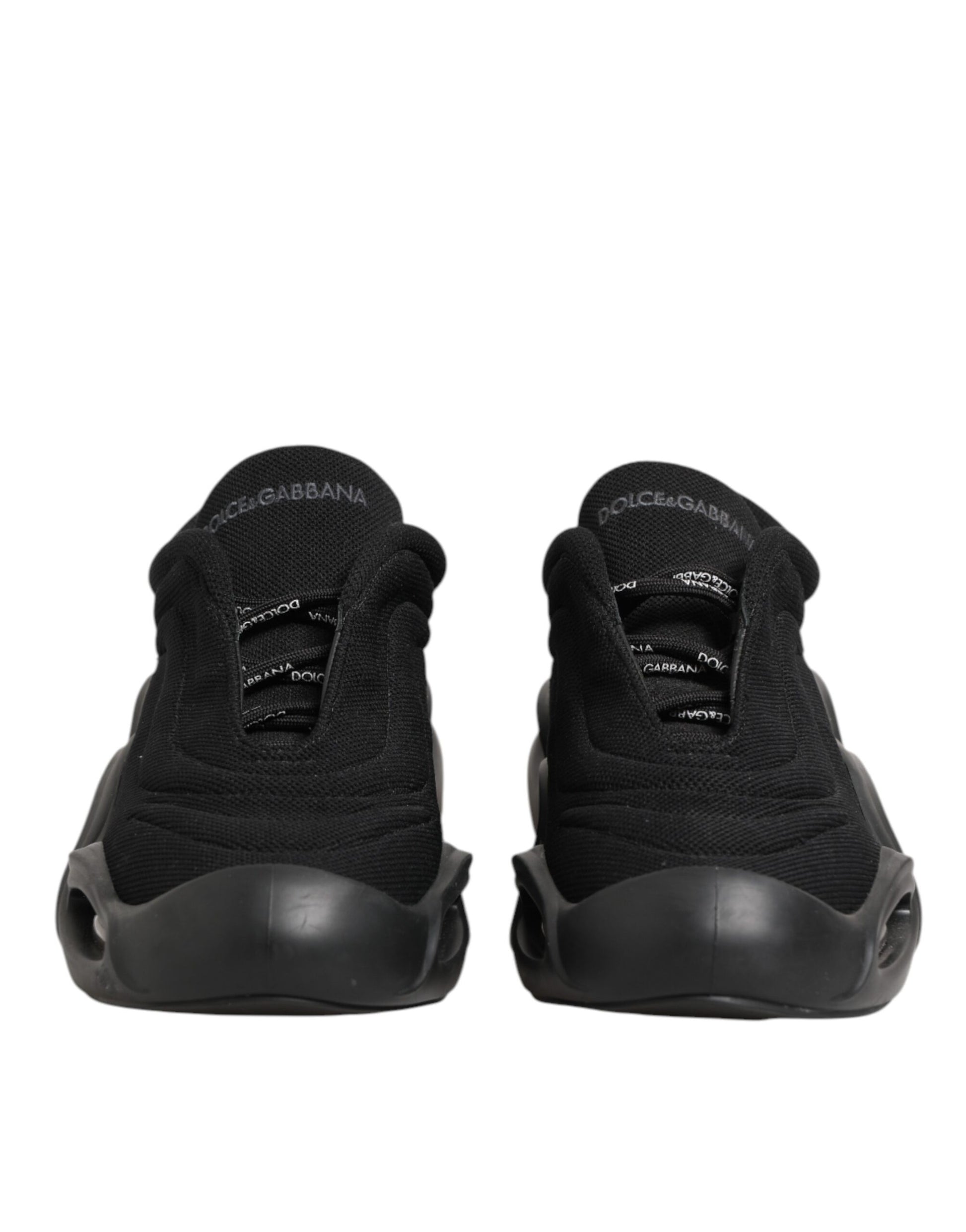 Pair of black lace-up sneakers with white logo on side, designed by Dolce & Gabbana