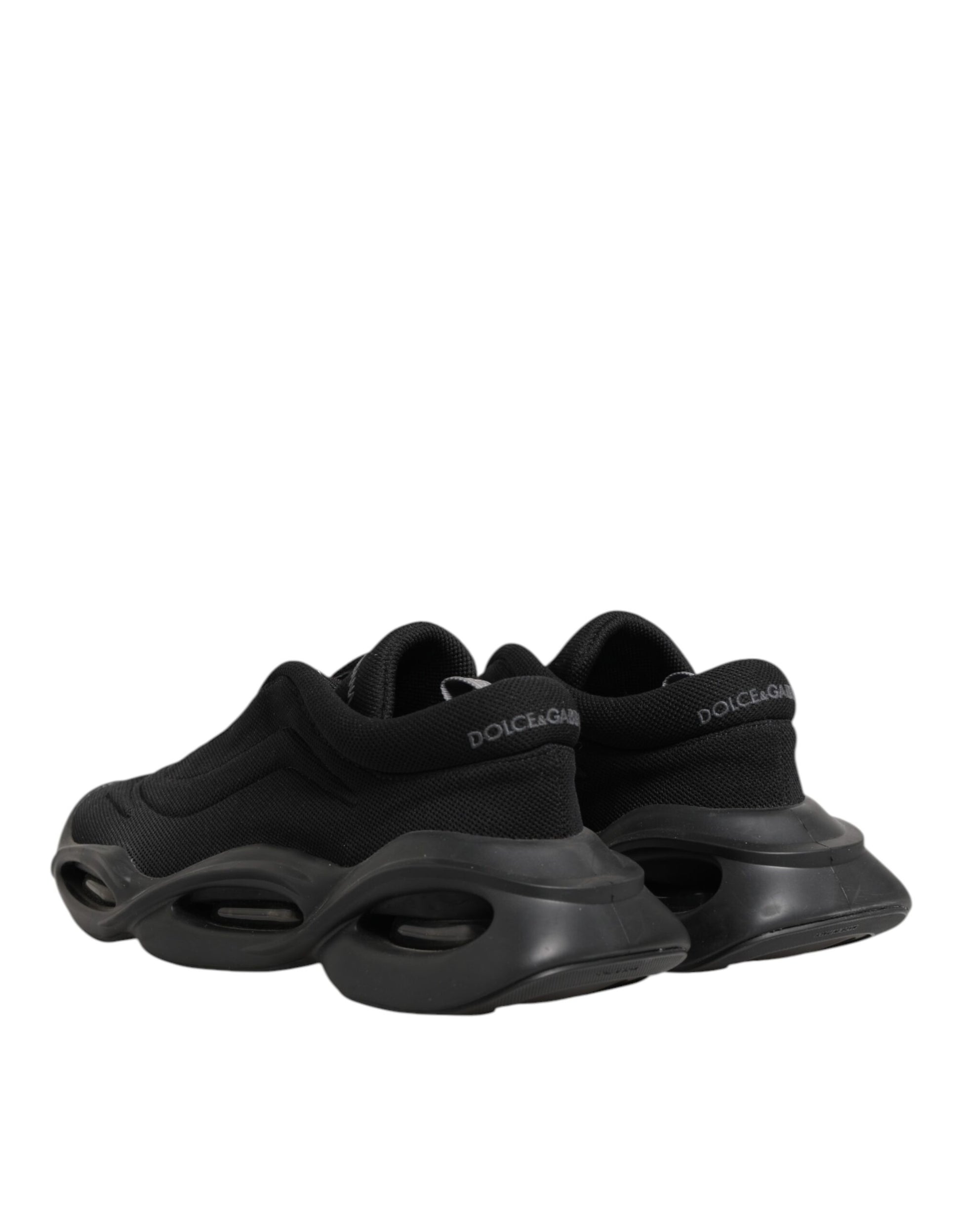 Black lace up sneakers with white soles, featuring a wave design on the side