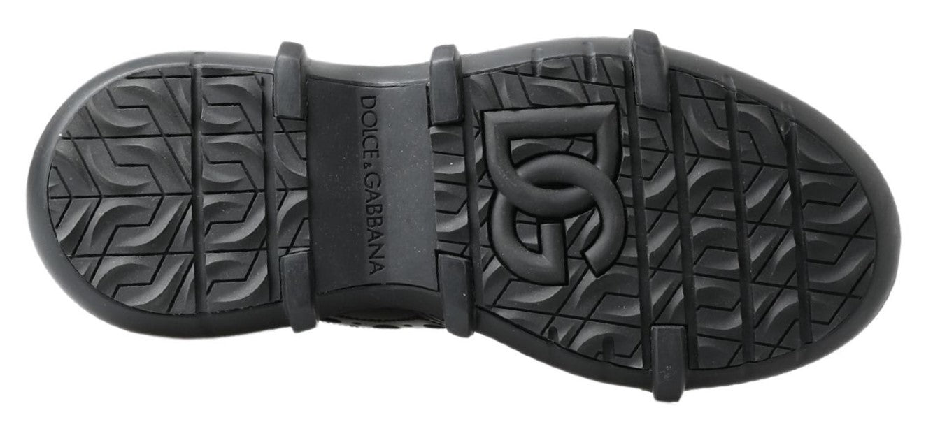 Pair of black rubber boots with treads on soles