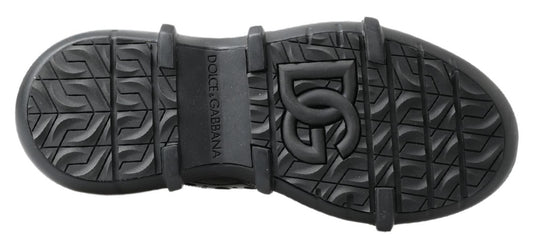 Pair of black rubber boots with treads on soles