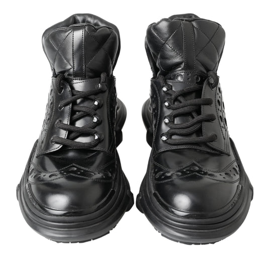 Pair of black leather boots with laces and a small heel