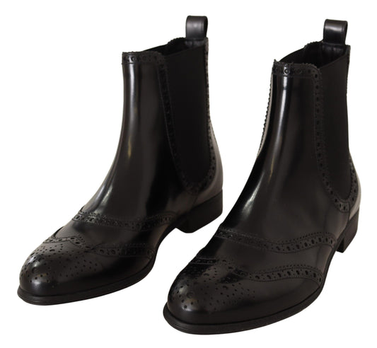 Pair of black leather boots with decorative stitching and perforated detailing