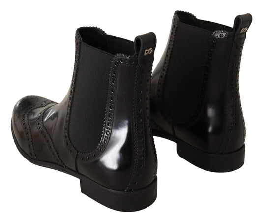 Pair of black leather boots with laces and a zipper on top