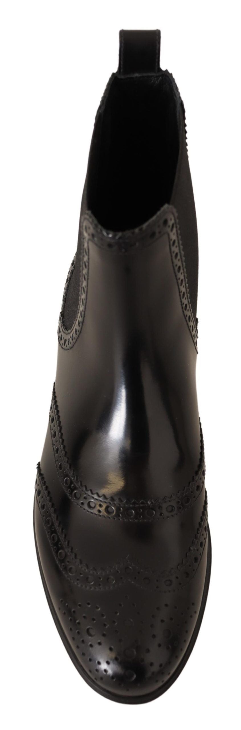 Pair of black boots with decorative pattern on side