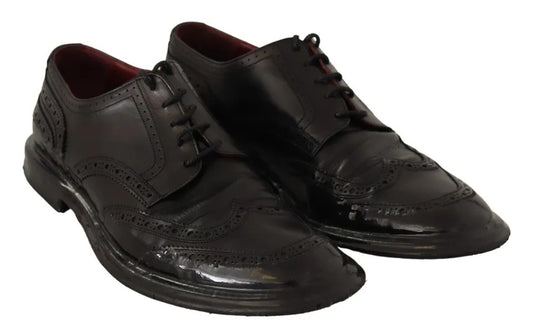 Pair of black leather brogue oxford dress shoes with laces and a small heel
