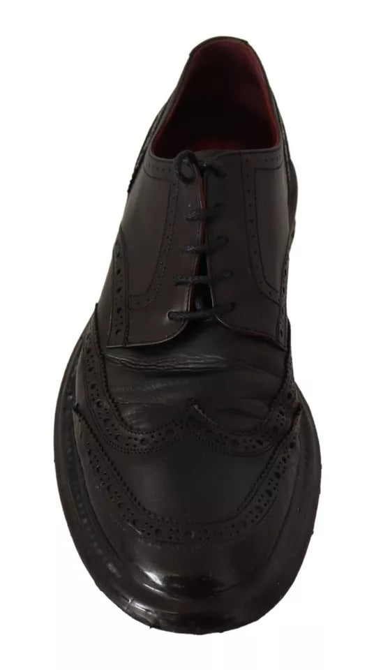 A pair of black leather brogue oxford dress shoes with laces and a shiny finish