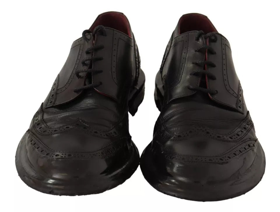 Pair of black leather brogue oxford dress shoes with laces and red stitching