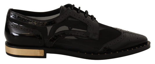 Pair of black dress shoes with gold accents and laces