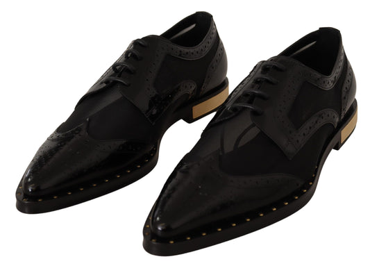 Pair of black dress shoes with gold accents and laces