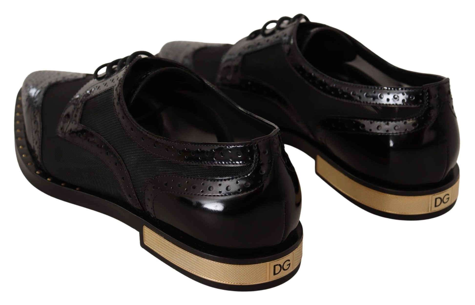 Pair of black patent shoes with gold trim and heels
