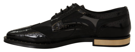 Pair of black dress shoes with gold accents and a patterned design on the side
