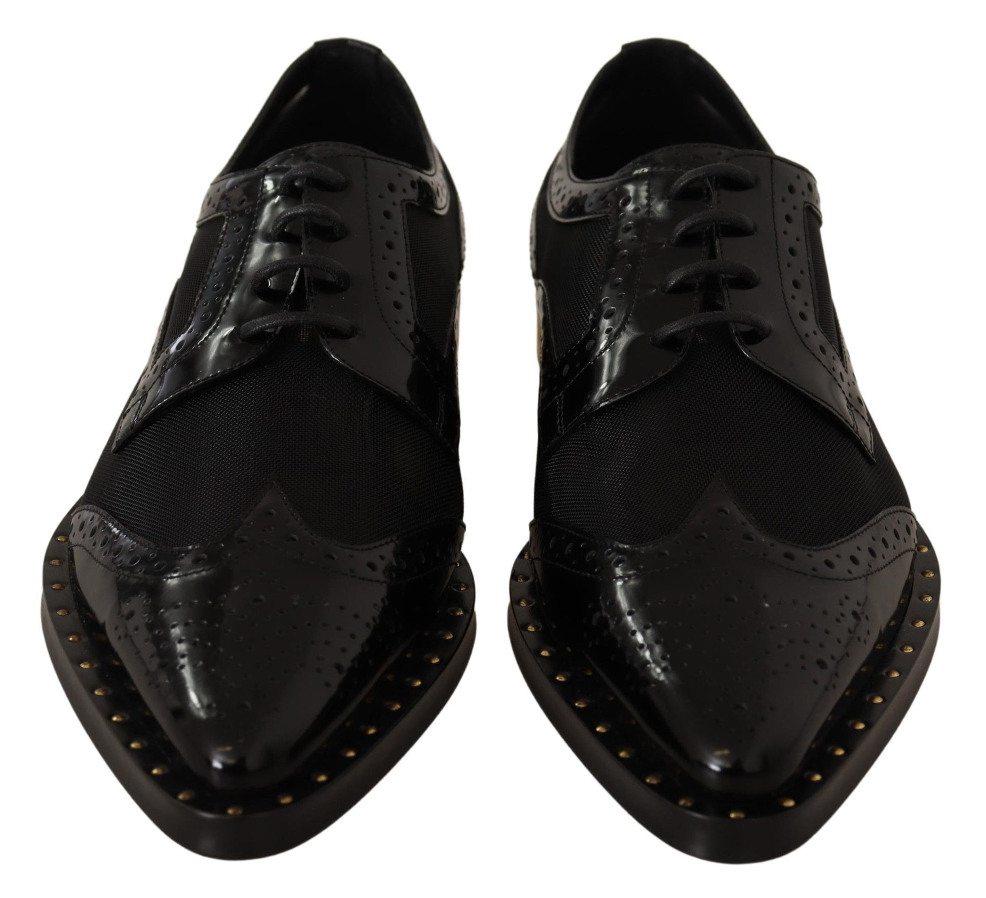 Pair of black leather shoes with laces and gold studs on soles