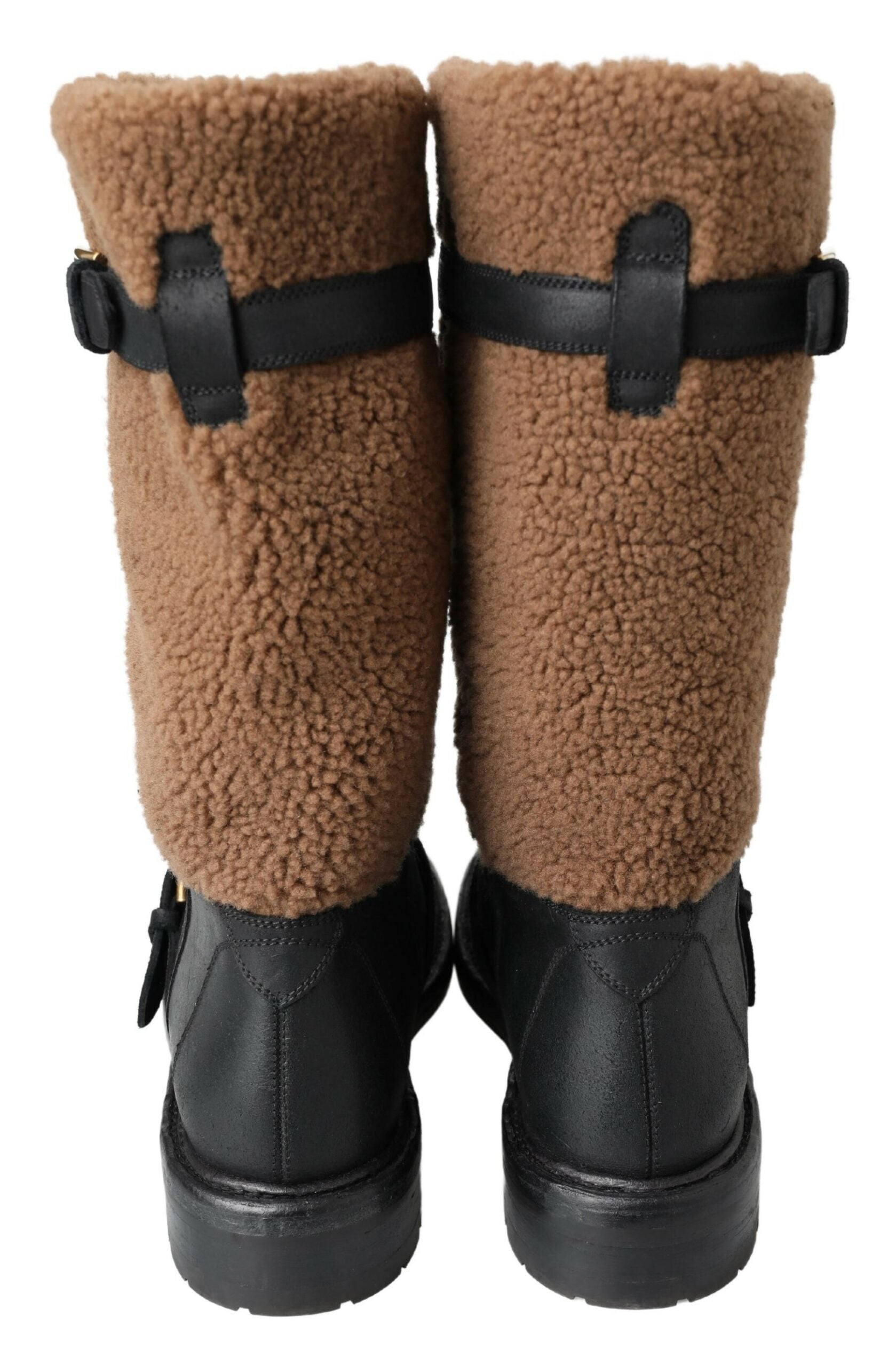 Pair of brown fur lined boots with black straps and buckles
