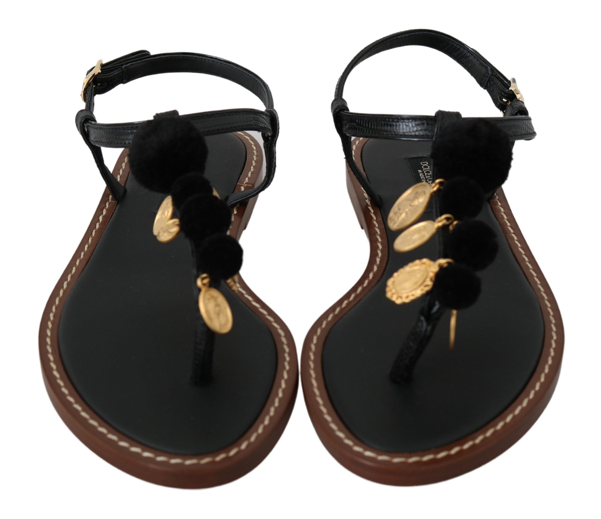 Pair of women's sandals with black straps and brown soles, featuring gold accents and fuzzy trim
