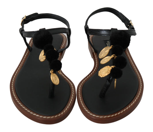 Pair of women's sandals with black straps and brown soles, featuring gold accents and fuzzy trim