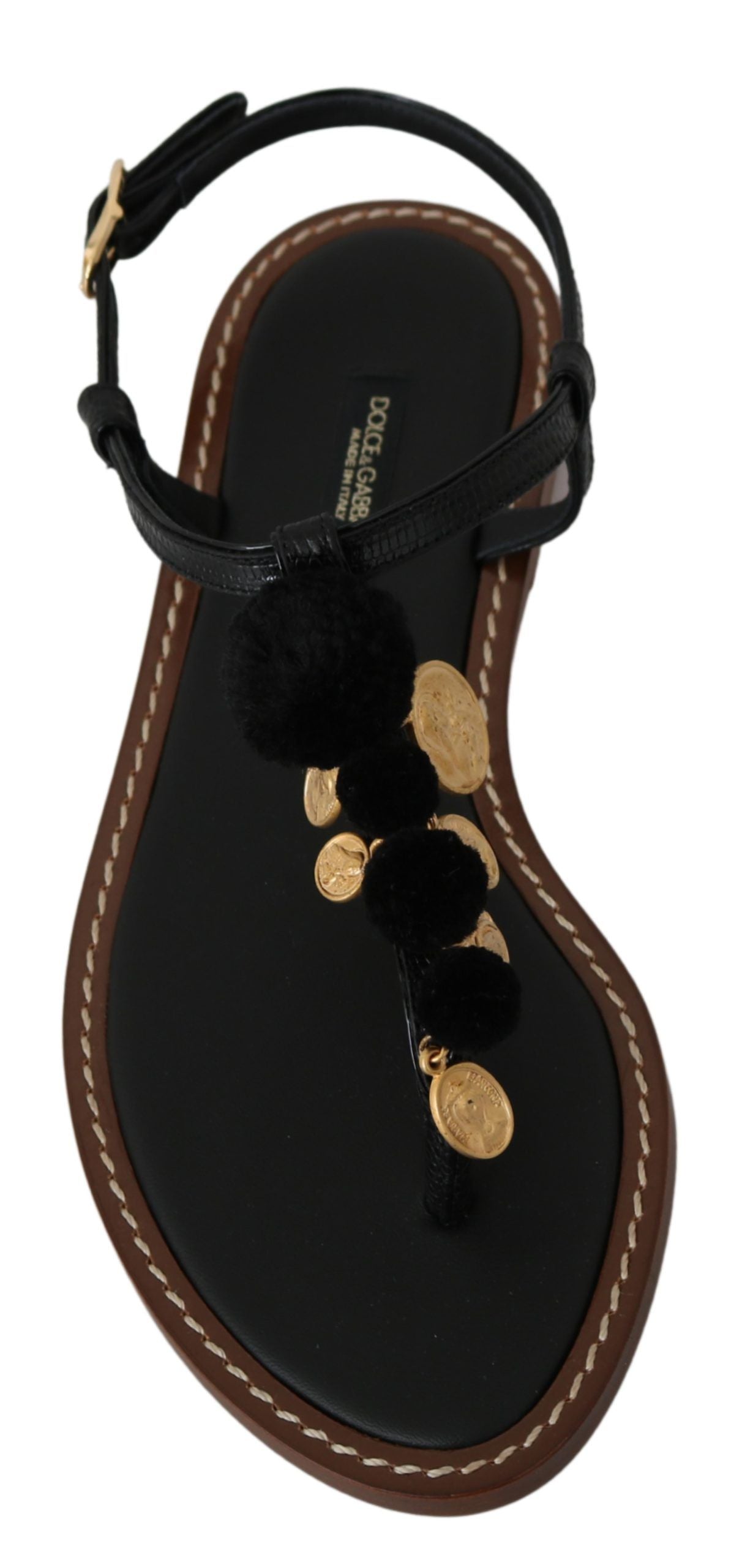 Black flip flop with gold accents and a brown strap