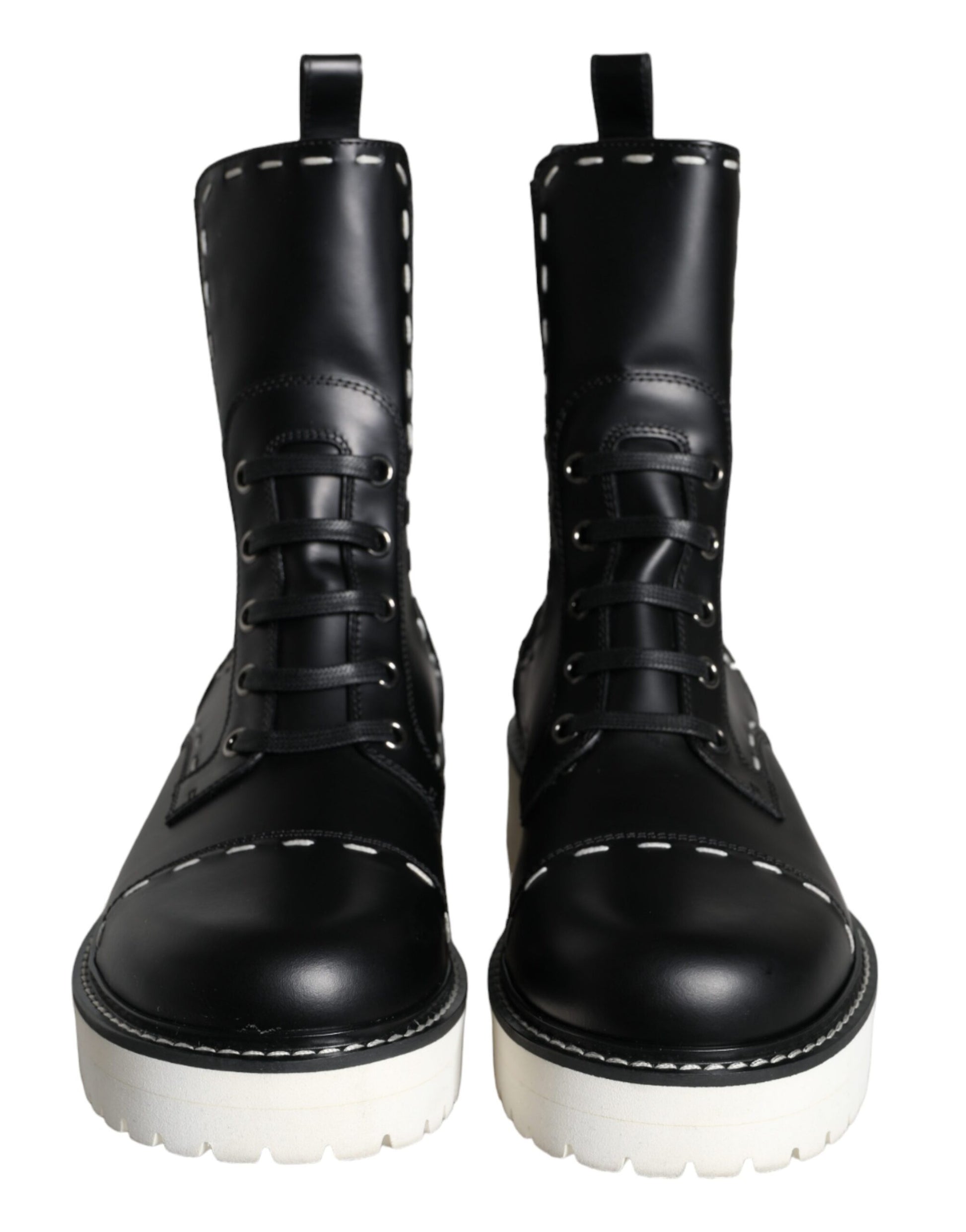 Pair of black leather boots with white laces and soles