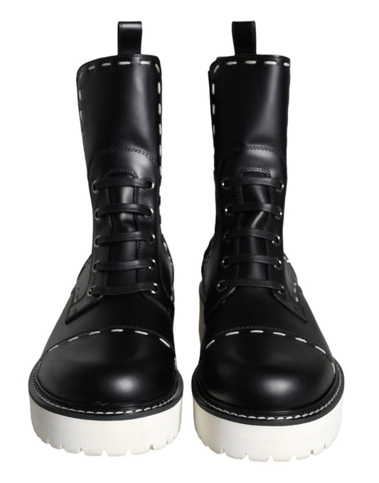 Pair of black leather boots with white laces and soles