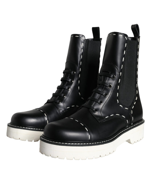 Pair of black boots with white soles