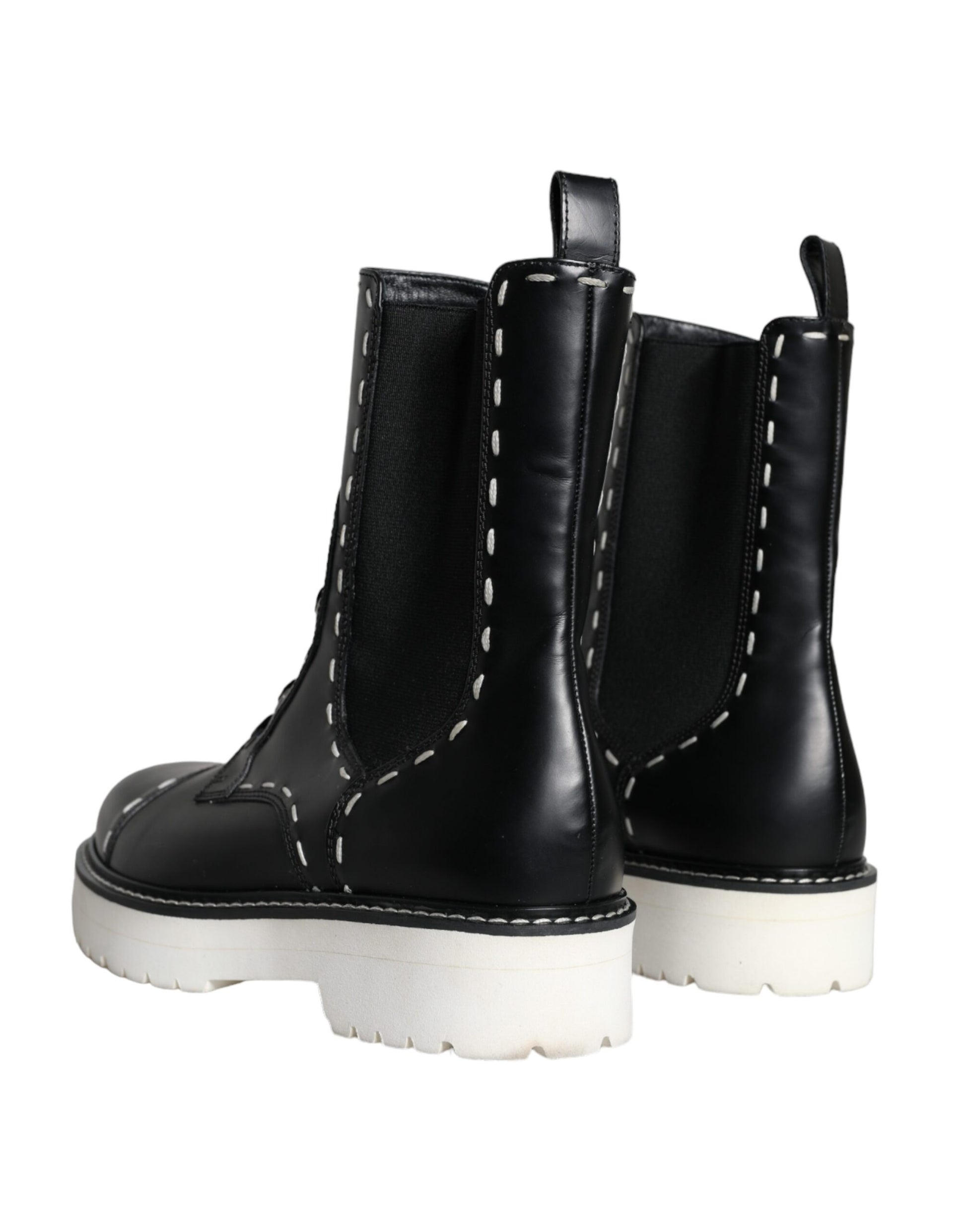 Pair of black boots with white soles