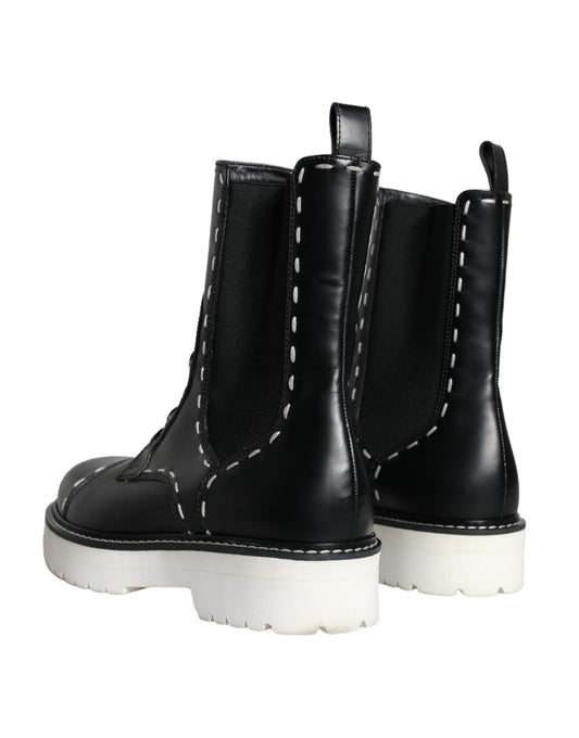 Pair of black boots with white soles
