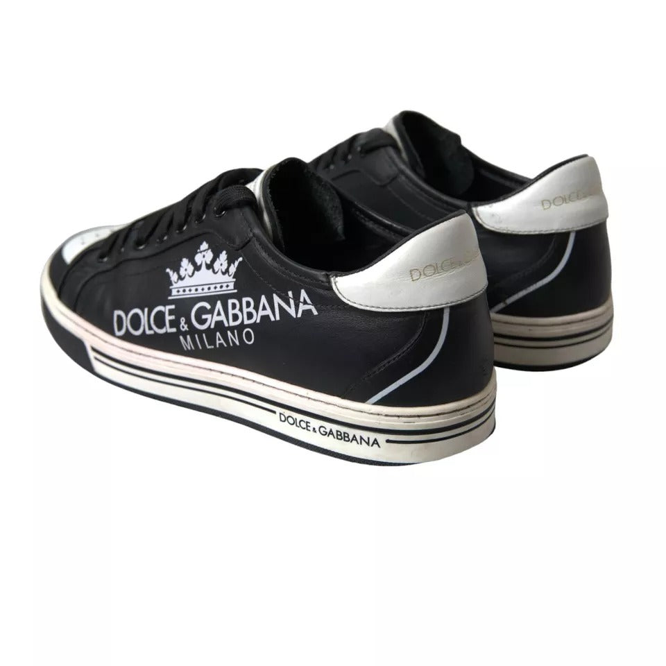 A pair of black leather sneakers with white laces and a crown logo on the side
