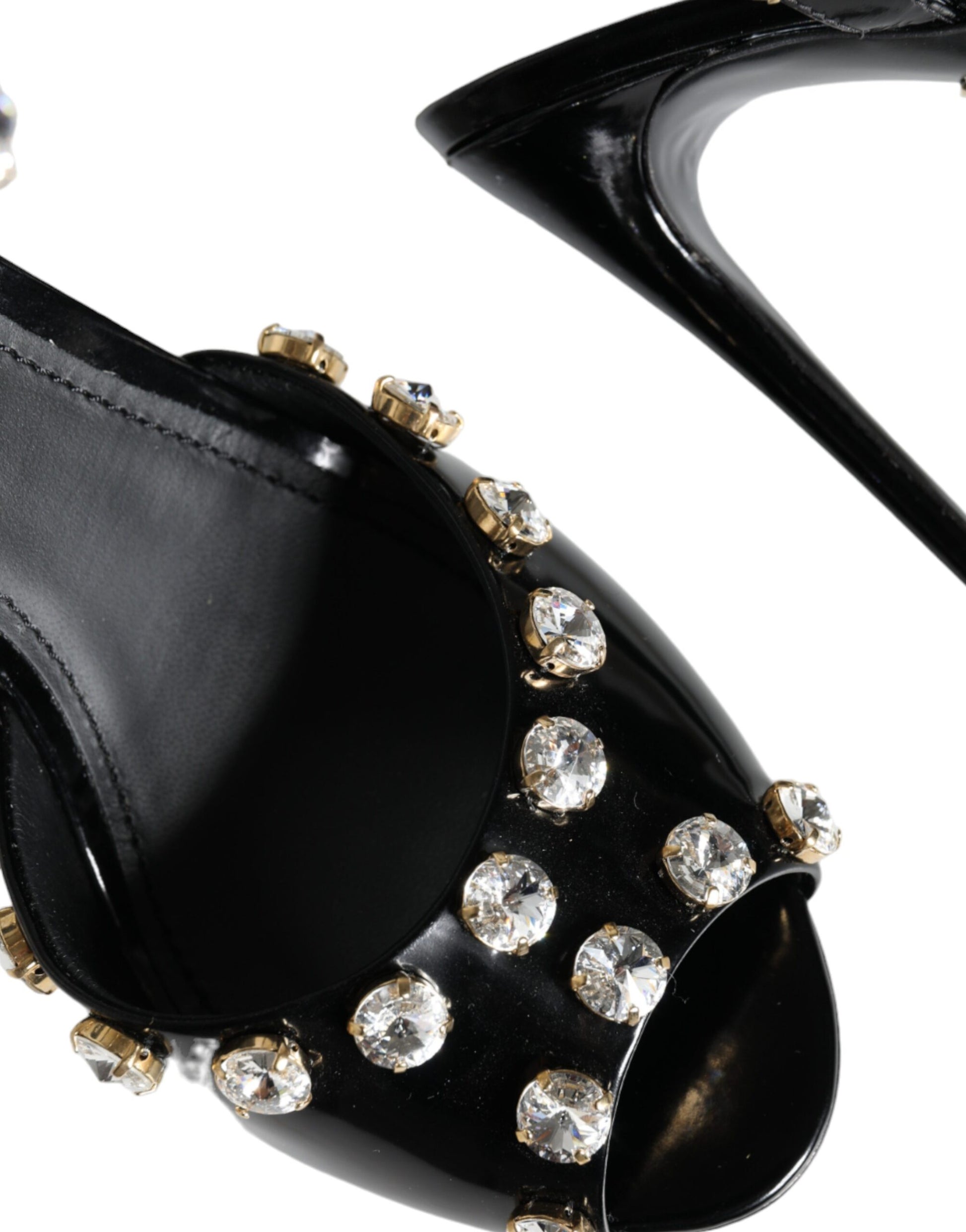 Black high heel shoe with gold studs on toe