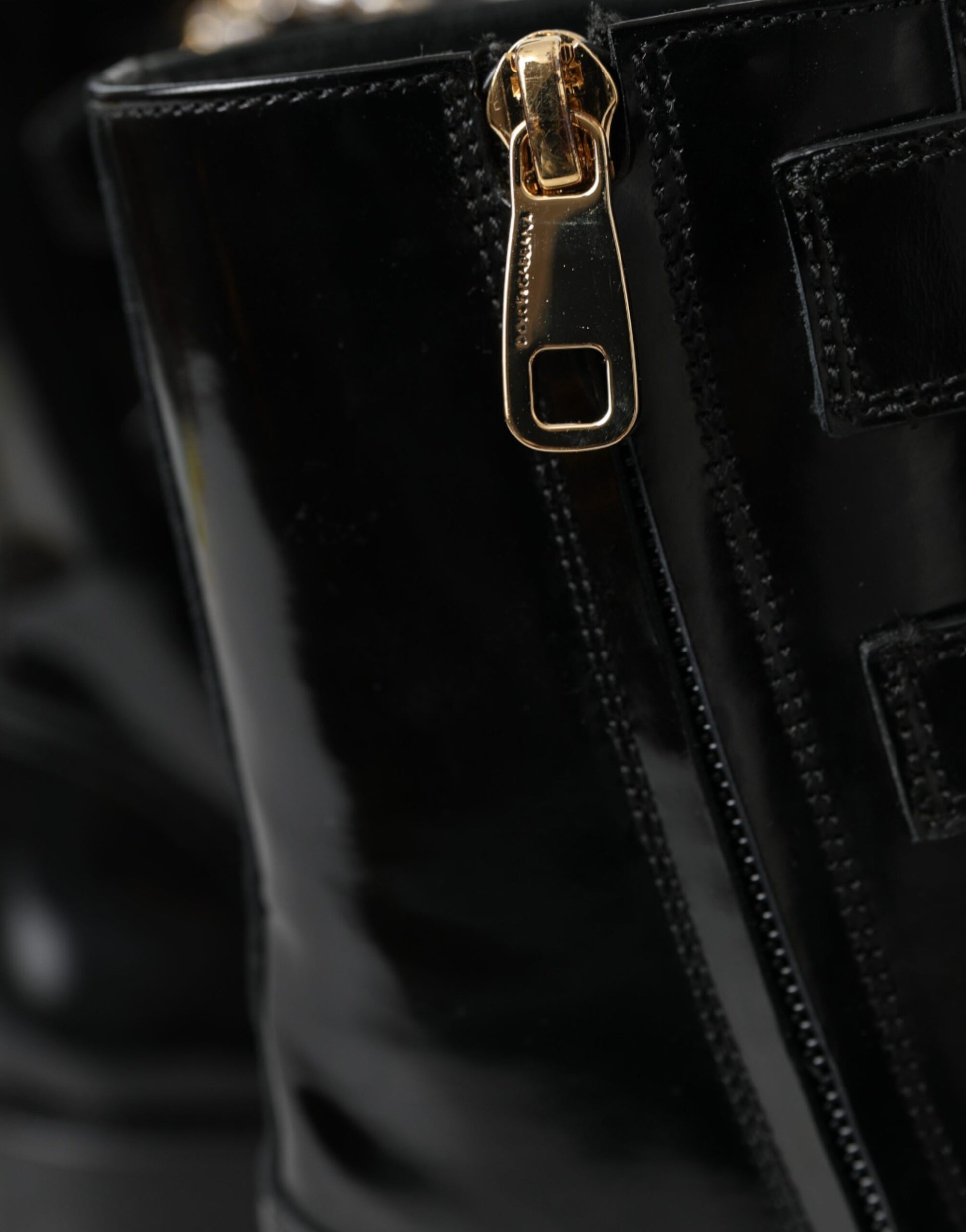 Black leather boot with gold buckle