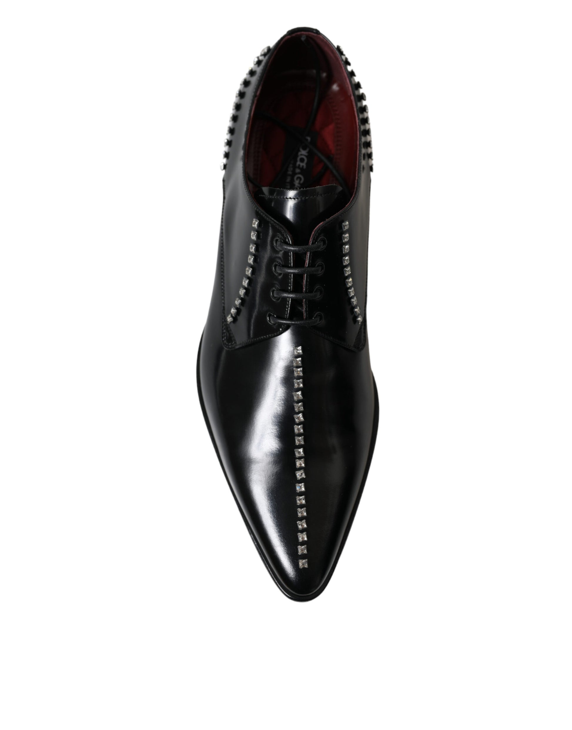 Black dress shoe with red laces and studs on toe cap