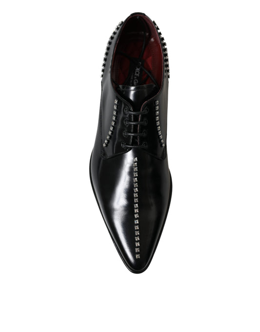 Black dress shoe with red laces and studs on toe cap