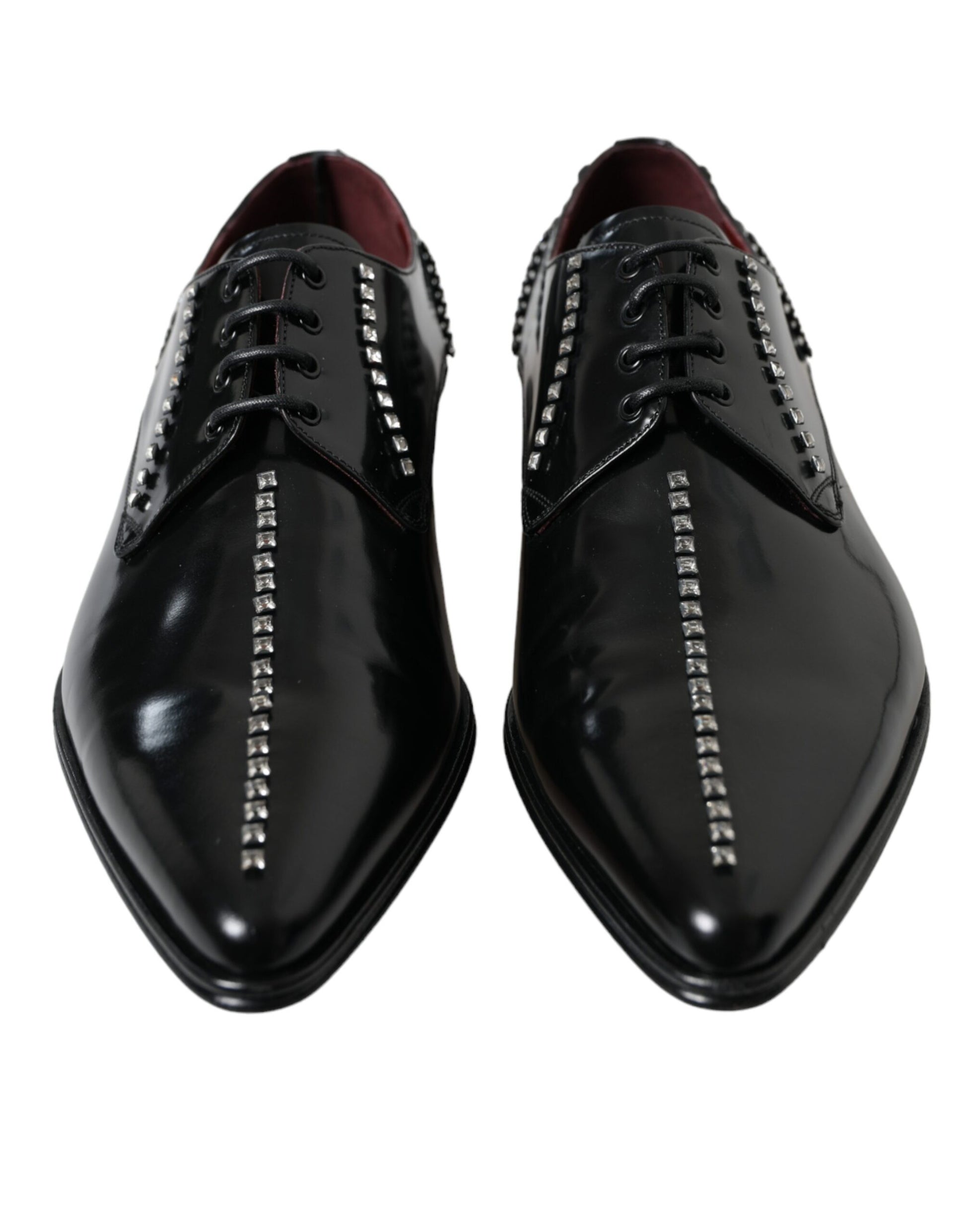 Pair of black dress shoes with silver studs on laces